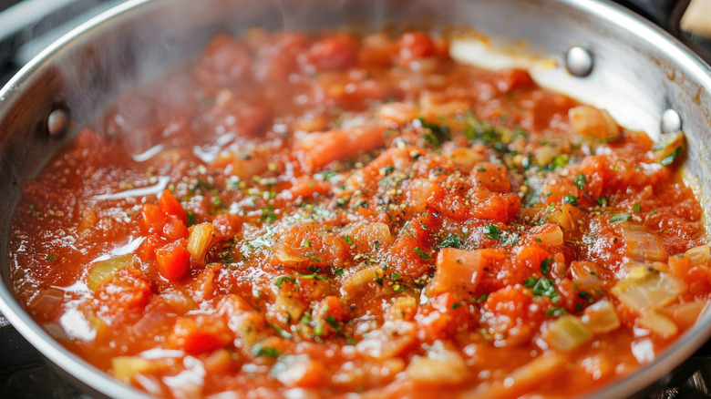 Tomato sauce simmering in a cast iron pan