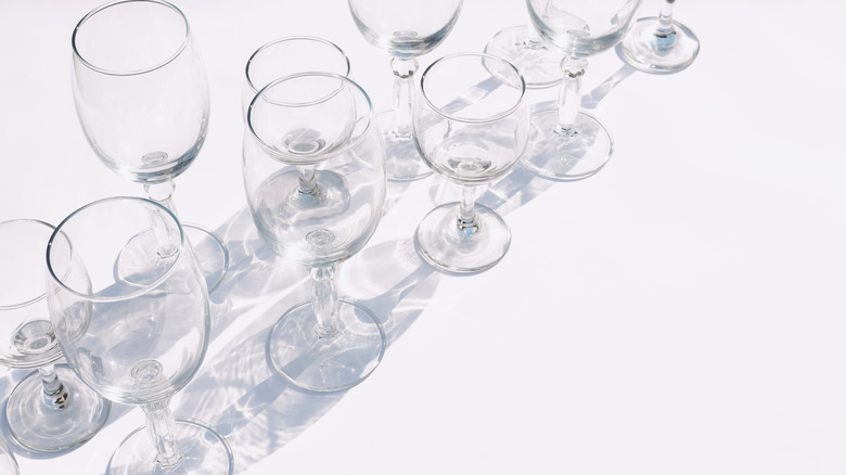 an array of empty wine glasses on countertop
