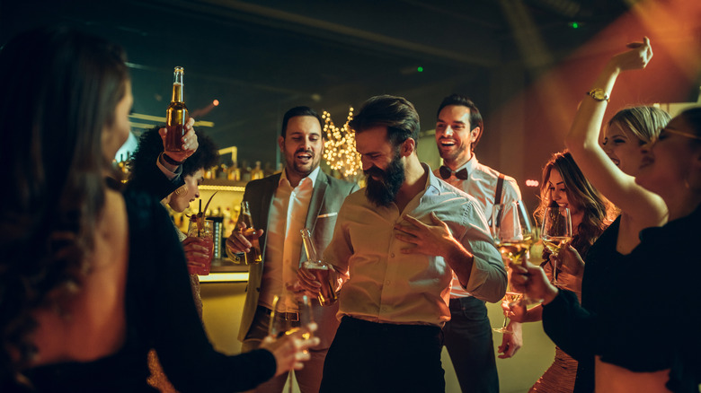 People standing up, having a good time at a bar