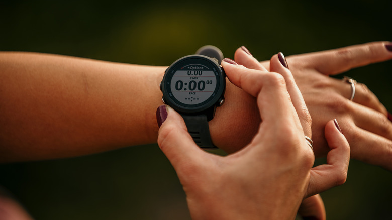 Hand setting the time on a stopwatch