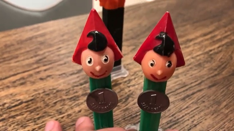 Hand holding two Sparefroh A PEZ dispensers