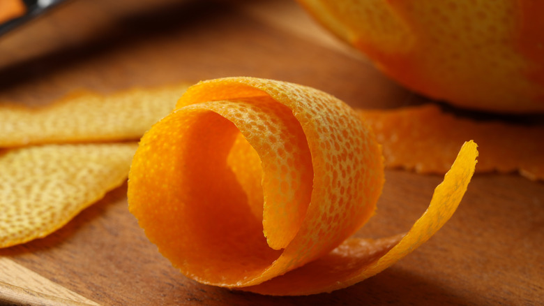 Close up of orange peel on a wooden board