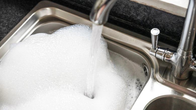 Kitchen sink filled with soapy water