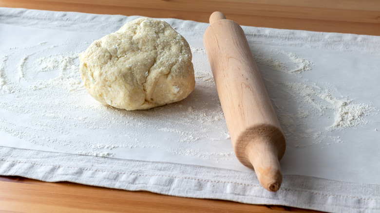 raw pizza dough with bits of cottage cheese