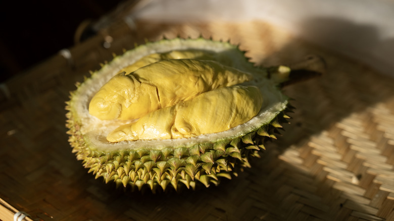 halved durian on wicker basket