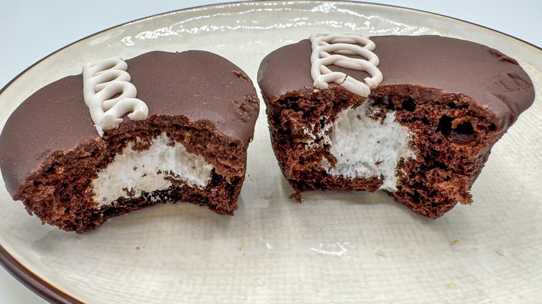 Hostess cupcakes cut in half on a plate