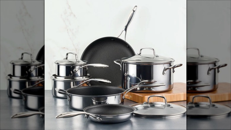 a set of Circulon stainless steel cookware on a gray counter