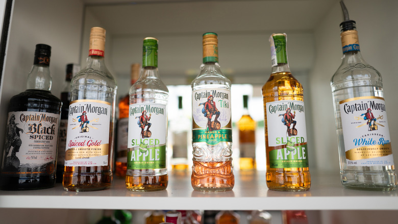 Bottles of various rums on a shelf behind a bar
