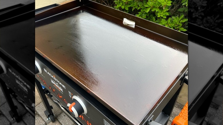 Blackstone grill covered with a layer of oil after being seasoned