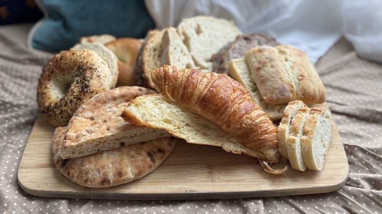 A variety of Costco bread on a wooden cutting board