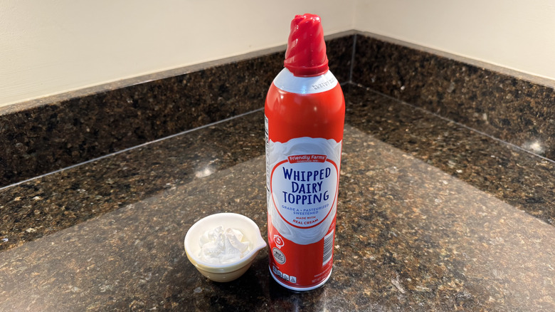 Friendly Farms canned whipped cream beside filled white dish on countertop