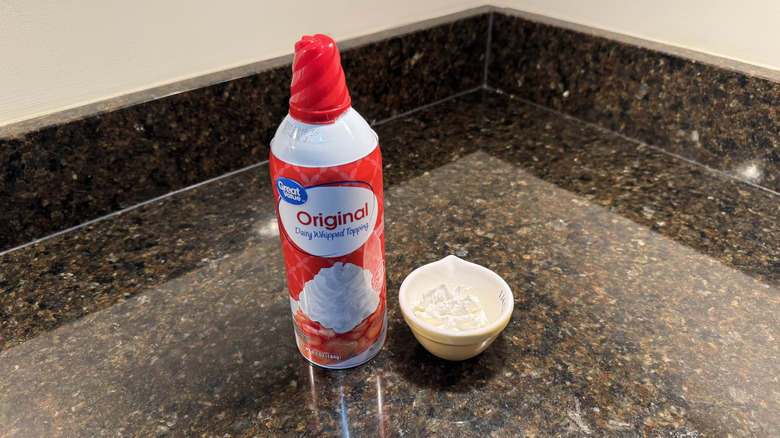 Great Value canned whipped cream beside filled white dish on countertop