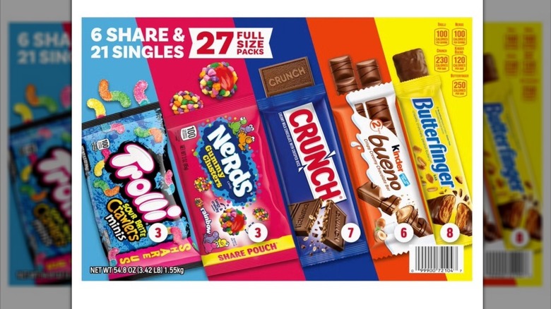 The candy bars are lined up from left to right: Trolli, Nerds, Crunch, Kinder, and Butterfinger.