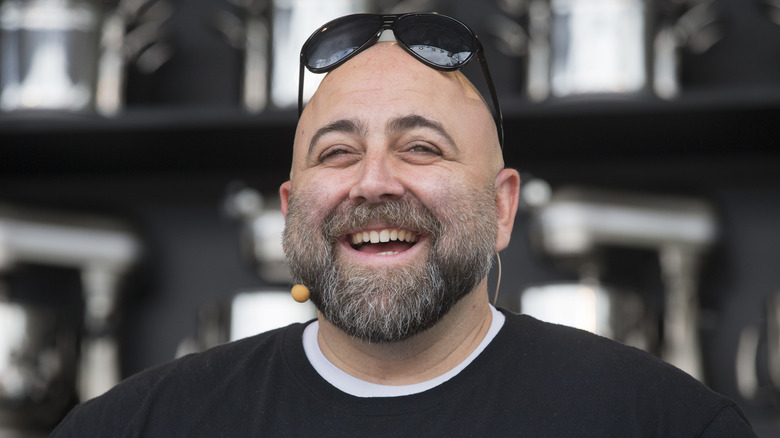 Chef Duff Goldman smiling with sunglasses on top of his head