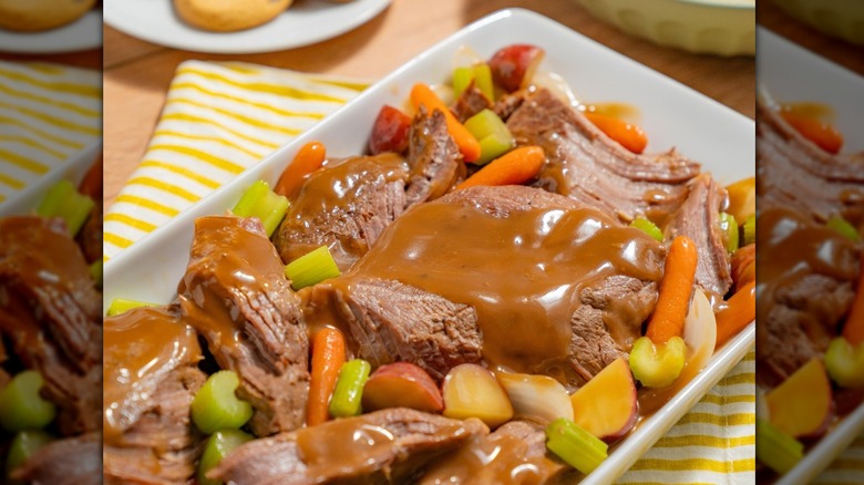 A plate of pot roast with vegetables and gravy at Golden Corral