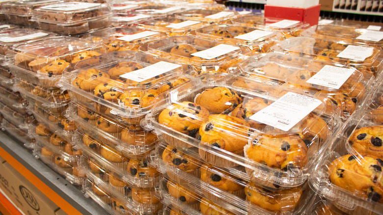 A large stack of Costco pre-packaged bakery-style muffins