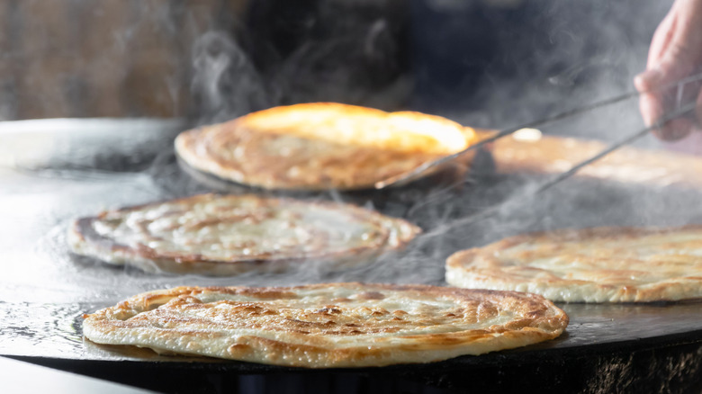 Pan de campo flatbread cooking on a flattop