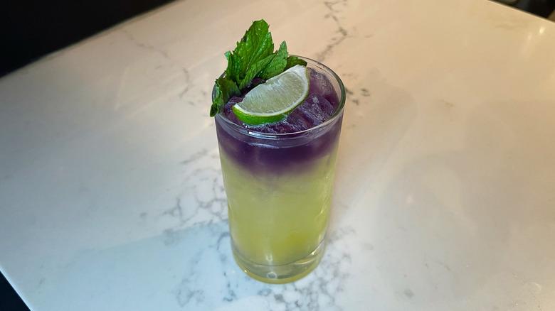 The Indigo Sunset cocktail from Bonefish Grill on a marble background