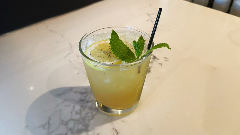 The Mango Bourbon Sour cocktail from Bonefish Grill on a marble background