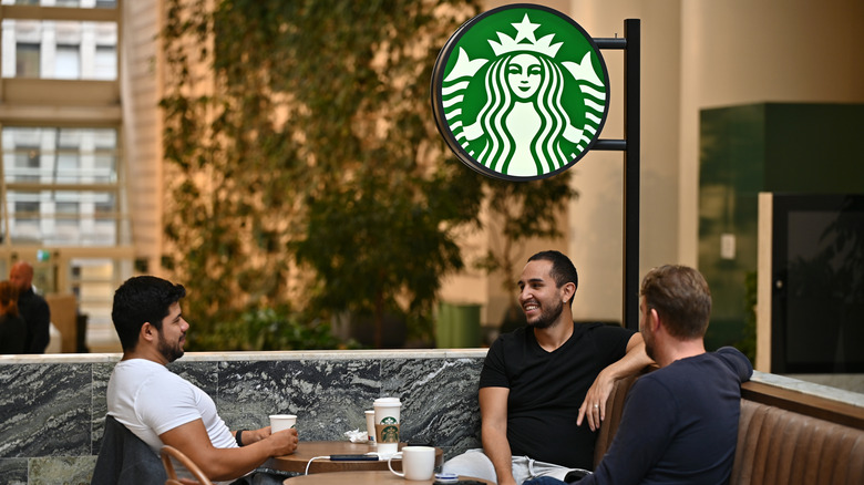 Friends enjoying coffee together in Starbucks