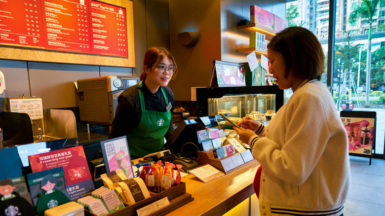 Customer paying for Starbucks at checkout