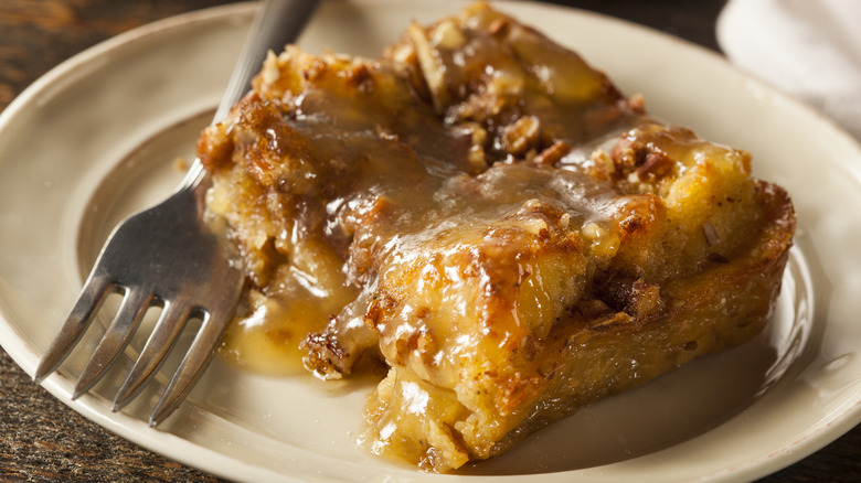 Moist bread pudding on a plate with a fork