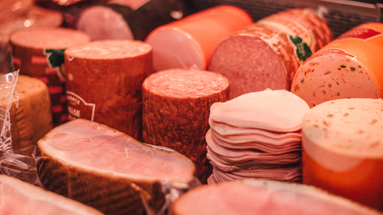 Closeup of various deil meats in case at store.