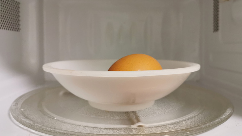 Whole egg in microwave in a plastic bowl