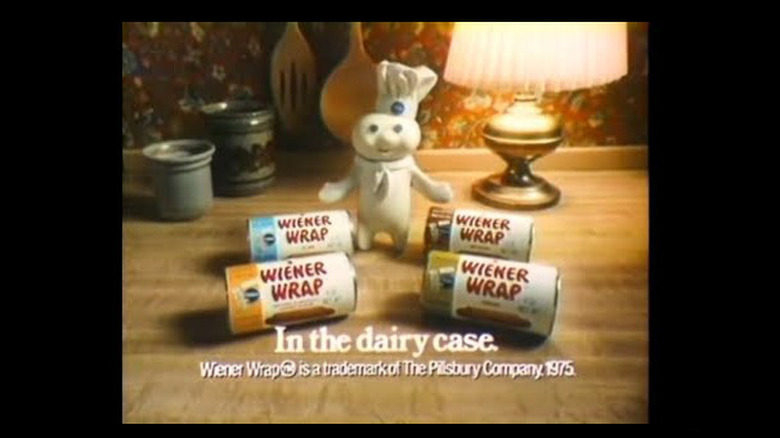 Wiener Wrap ad with Pillsbury Dough Boy and four packages of Weiner Wraps on table next to lamp