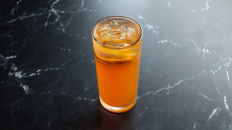 An Arnold Palmer on a black and white marble table