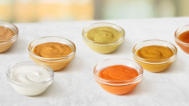 A selection of dipping sauces in glass containers