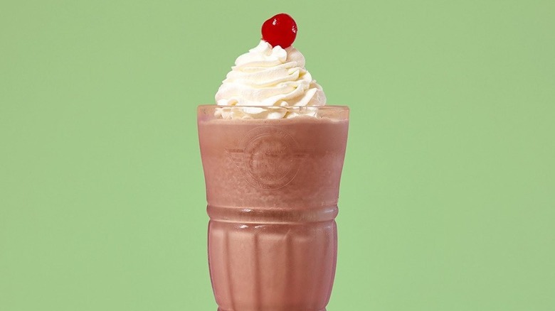A chocolate milkshake surrounded by chocolate chunks from Steak 'n Shake