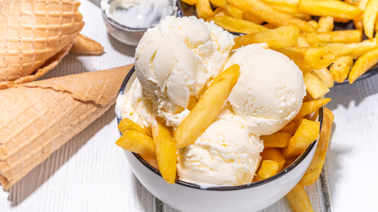 Vanilla ice cream scoops are served with waffle cones and French fries