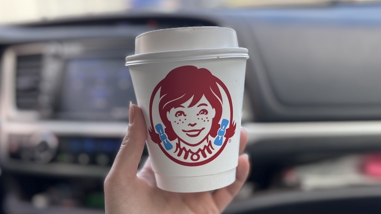 hand holding cup of Wendy's coffee