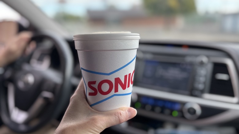 hand holding cup of Sonic coffee