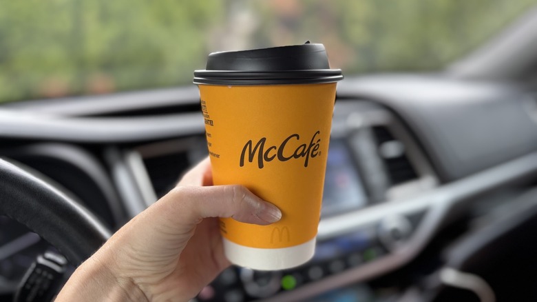 hand holding cup of McDonald's coffee