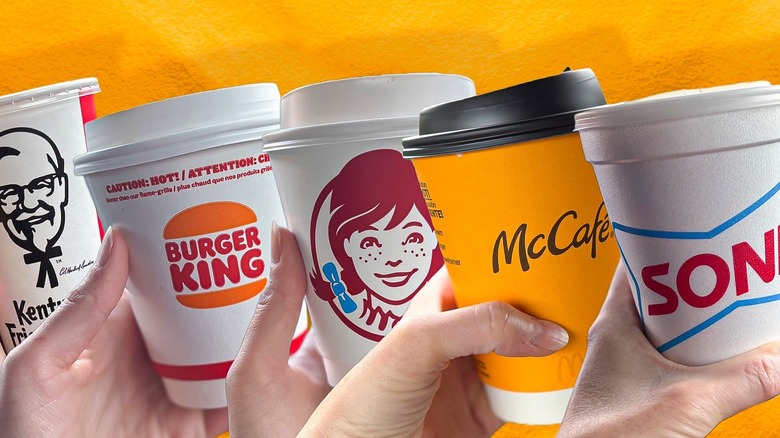 lineup of fast food coffee cups against orange background