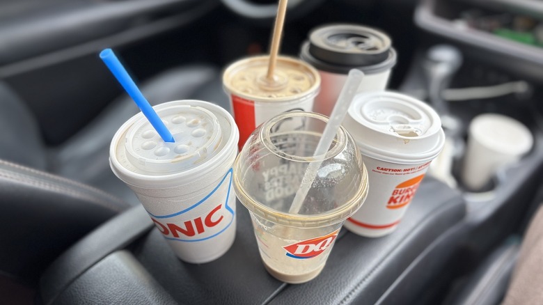 collection of coffee cups in car