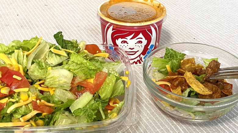 Wendy's taco salad on table, including a cup of chili