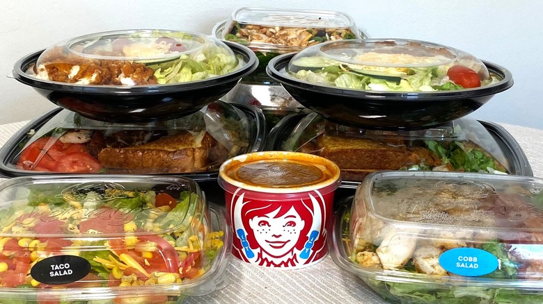 eight fast foods salads on a table