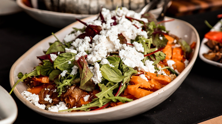 A sweet potato salad with a crumbled feta and various other ingredients