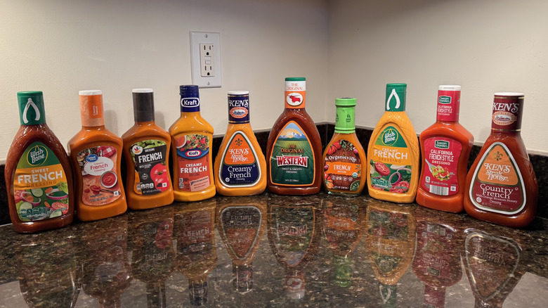 10 bottles of French dressings lined up on a countertop