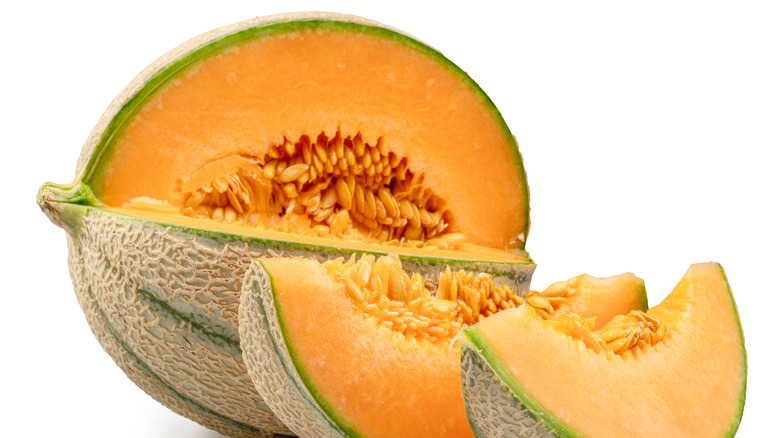 Two slices are cut from a whole cantaloupe