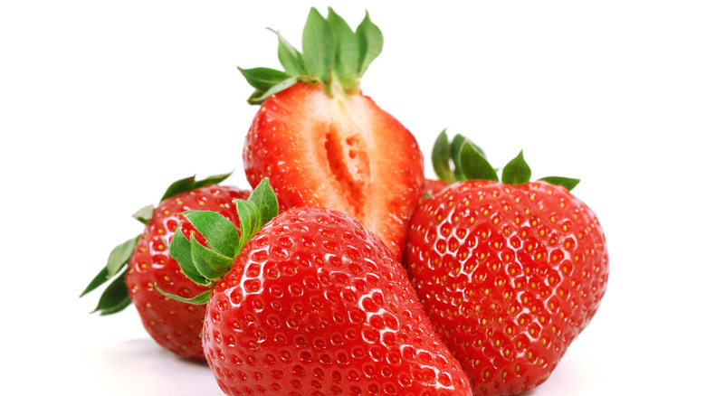 A pile of strawberries is pictured against a while background