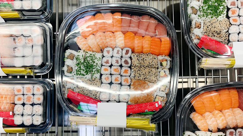 big platter of sushi in a grocery store case