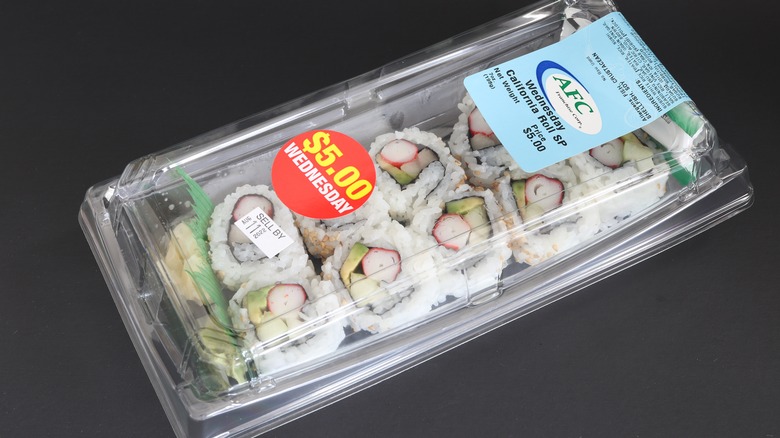 $5 sushi pack from Publix sitting on a black counter