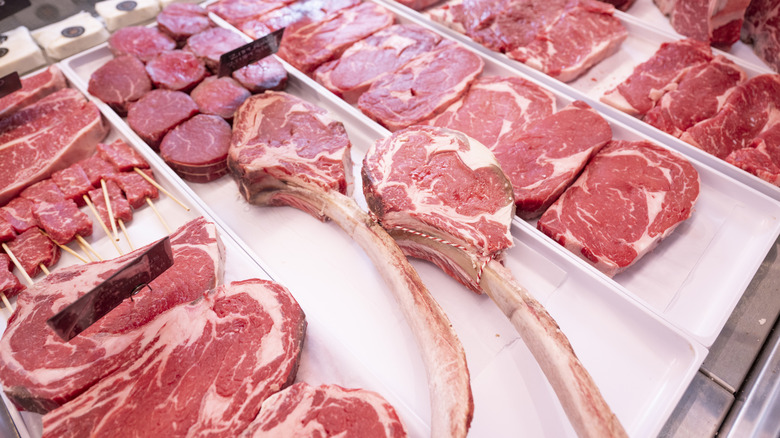 Assorted cuts of raw beef in a butcher shop