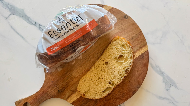 Artisan bread sourdough in package with a slice on a wooden surface