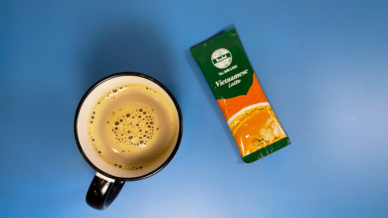 A packet of Beanhut's Vietnamese latte next to a mug