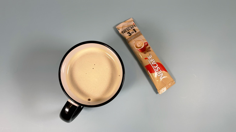 Nescafé's 3 in 1 latte packet next to a mug
